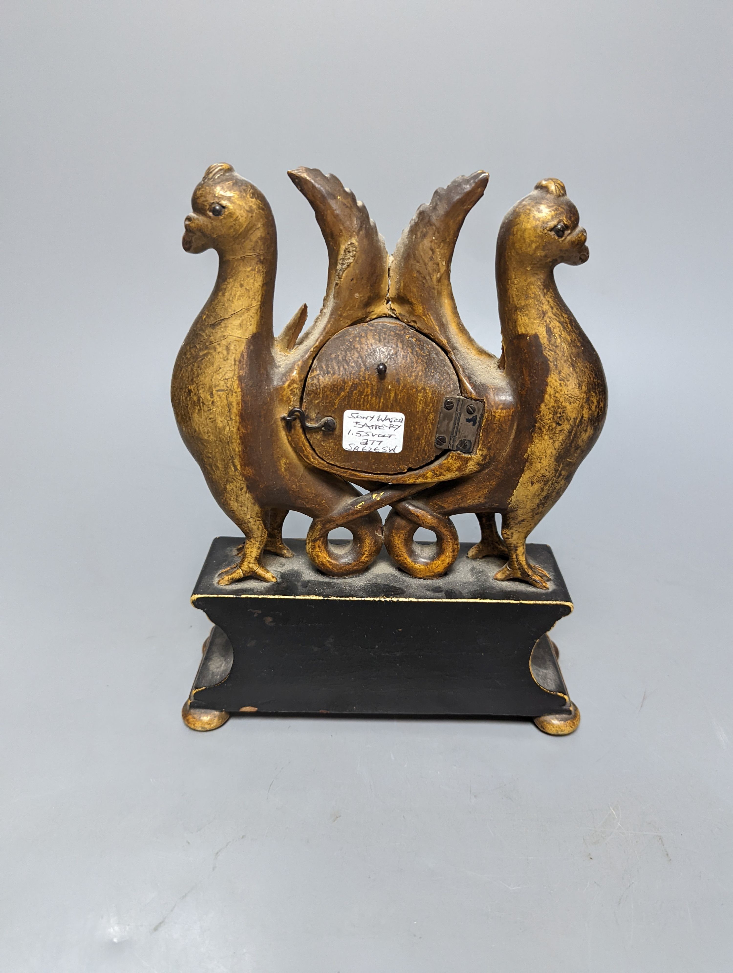 A carved and gilt watch stand, 22 cms high.
